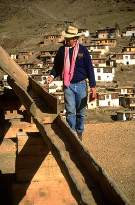 John Sanday inspects drainage on Palpung's roof.