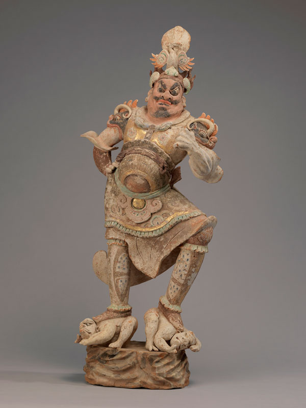 A pottery figure of a Lokapala quelling demons