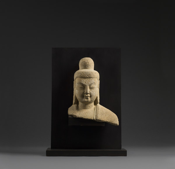 Sandstone head and shoulders of Buddha