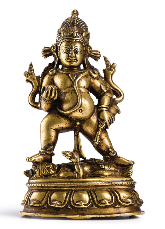 A copper-inlaid bronze figure of Kala Jambhala