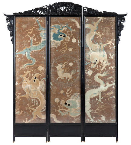 An ebonised three-fold dressing screen of large proportions