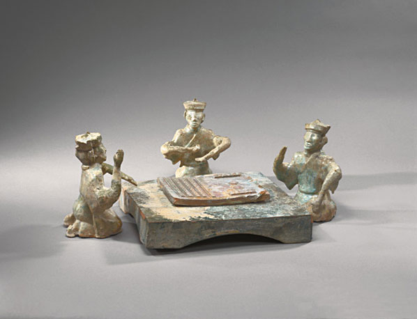 Three Capped Men (Probably Two Players and One Observer) <br>Kneeling around a Low Table and Playing Liubo