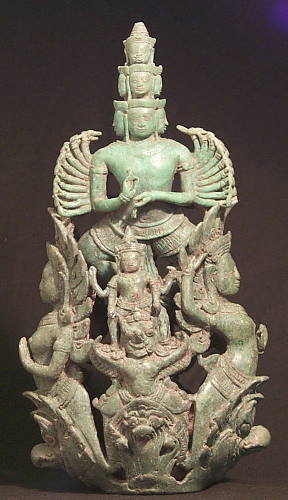 An unusual Janus Khmer bronze 20-armed figure, mounted as a battle standard with attendant figures