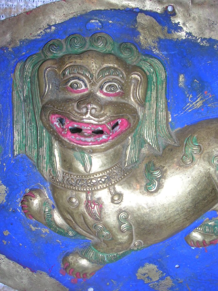 A lion in copper repouss� fire gilded with polychrome