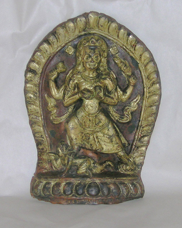 A gilt copper and cold gilded repousse plaque depicting Chamunda