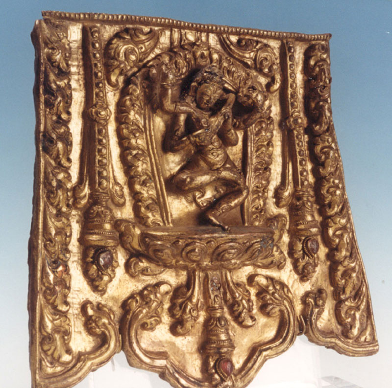 A repousse gilt copper panel