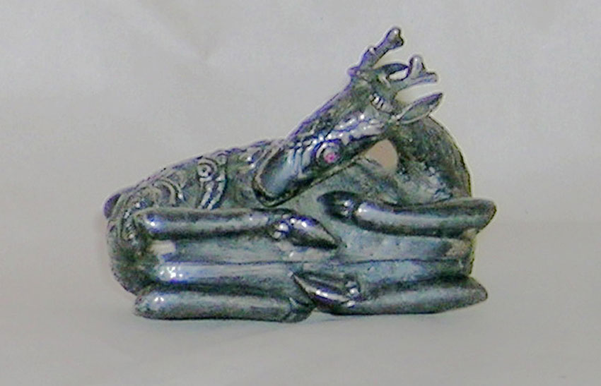An ornamental silver box in the form of a recumbent deer