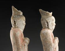 A pair of court attendants wearing a mask