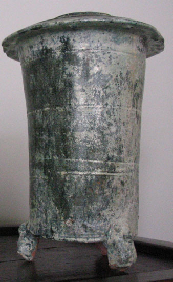 A iridescent  round tripod and a model of grain silos