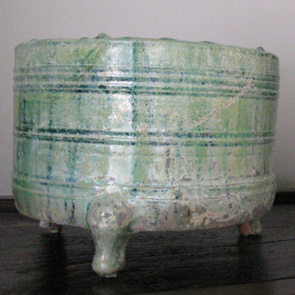 A iridescent  round tripod and a model of grain silos
