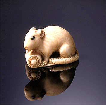 Netsuke of a rat on a scroll signed Tomochika