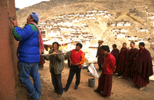 John Sanday, assisted by Tibetan workers, places tell-tales in the exterior wall of Palpung to monitor movement of a crack.