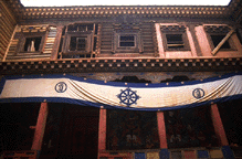 North wall of Palpung's main courtyard shows repair to some wooden structures.