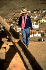 John Sanday inspects drainage on Palpung's roof.