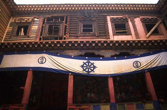 North wall of Palpung's main courtyard shows repair to some wooden structures.