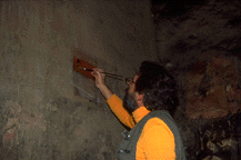 Carlo Giantomassi cleans a mural at Baiya.