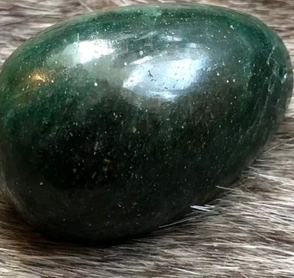 black gemstone with gold flecks