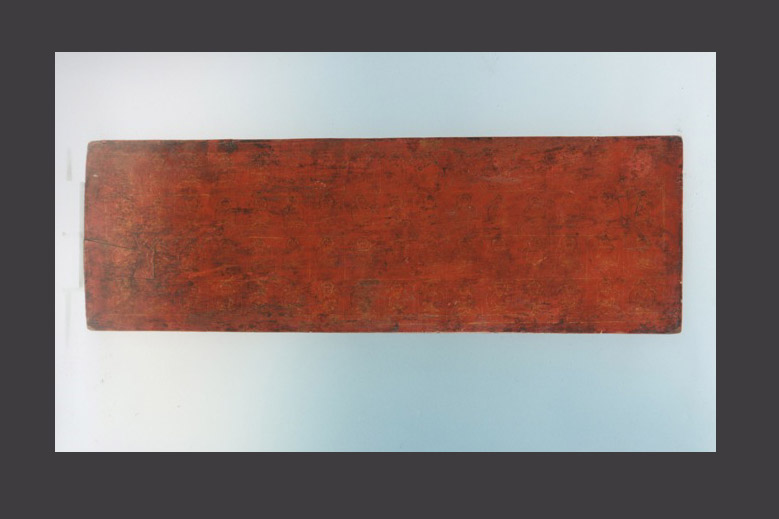 A red and gold lacquered manuscript cover