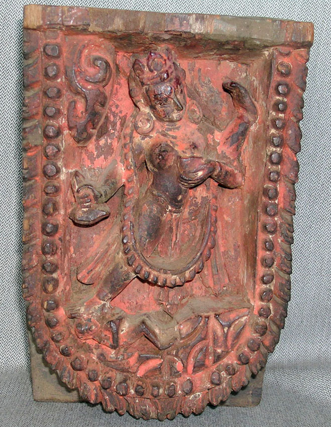 A carved wood temple ornament depicting <i>Savarbuddhadakini</i>