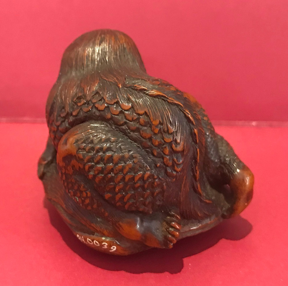 Boxwood netsuke of a kappa on a clamshell