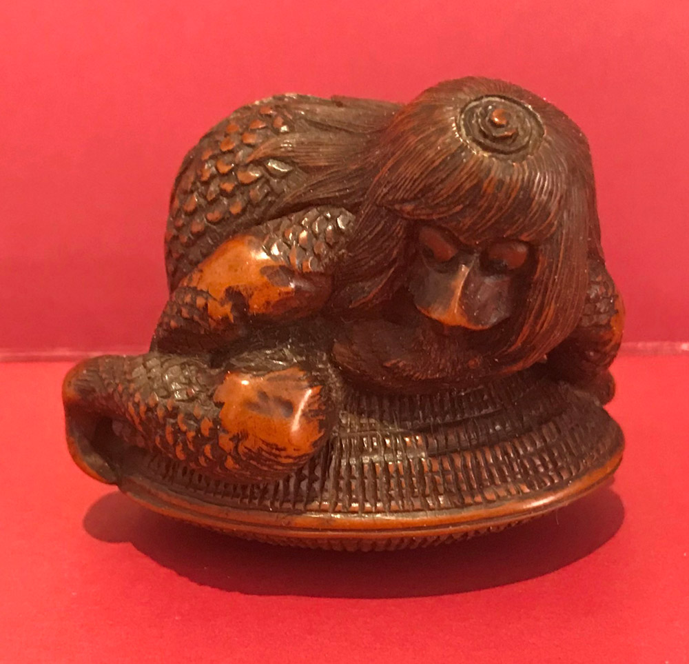Boxwood netsuke of a kappa on a clamshell
